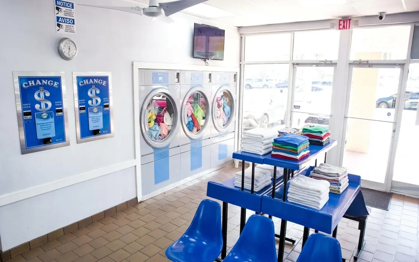 Stacked commercial dryers and folding area for business and AirBnB laundry