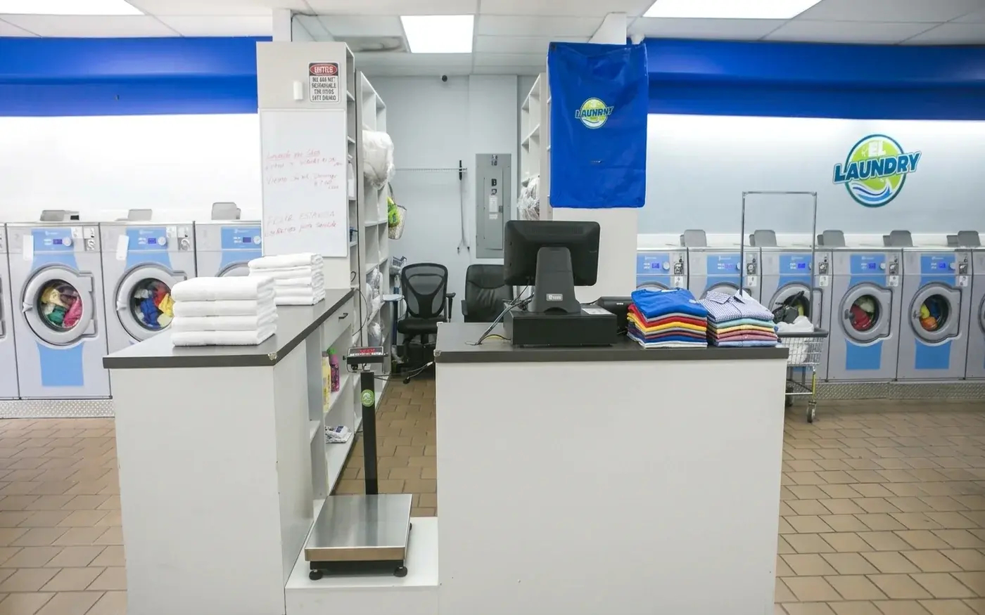 El Laundry drop-off wash and fold service counter with fresh folded laundry