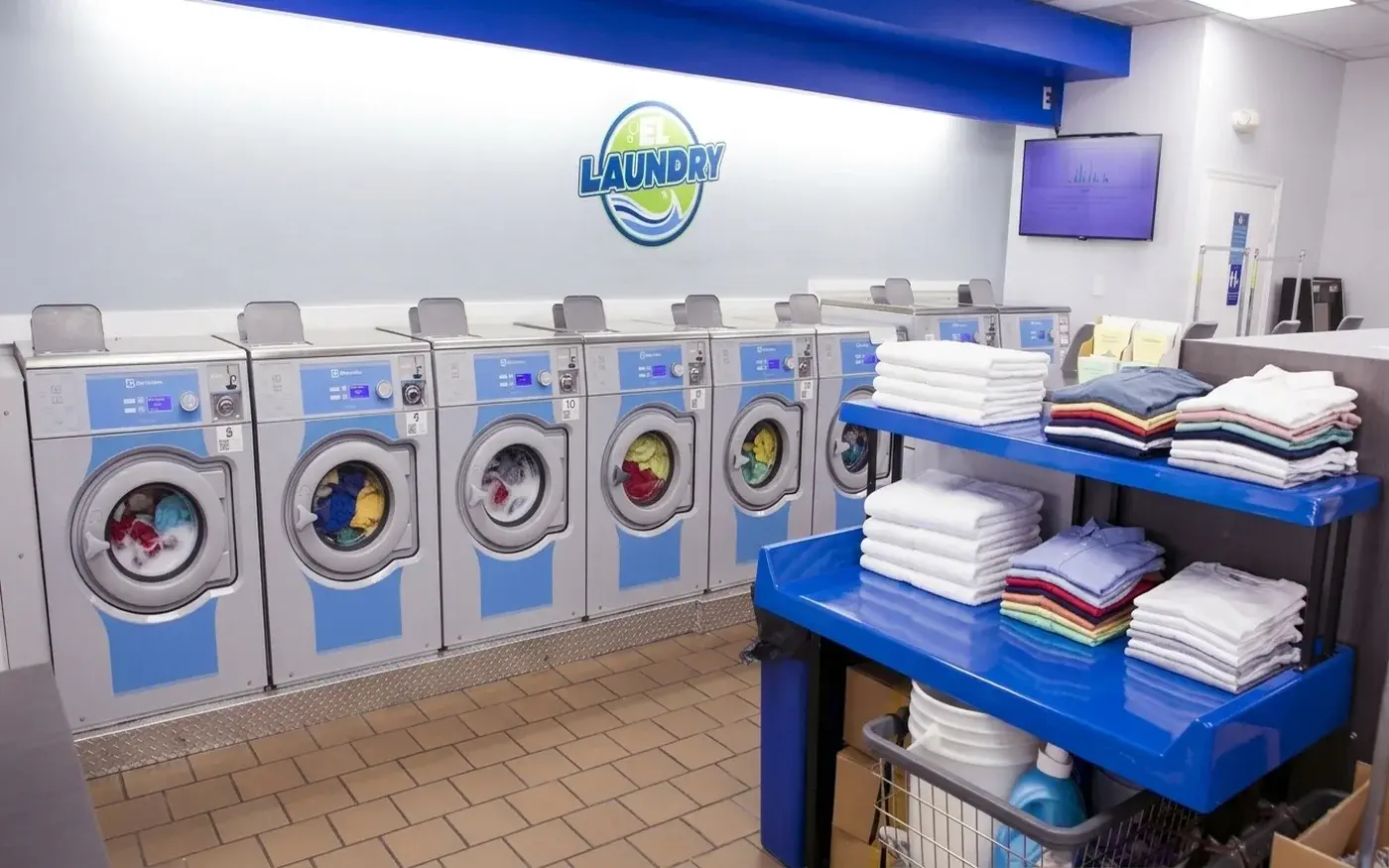 Row of high-speed commercial Electrolux washers at El Laundry Hialeah